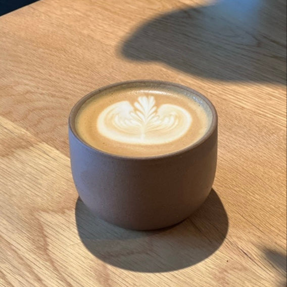 Cup of coffee with latte art on a wooden table
