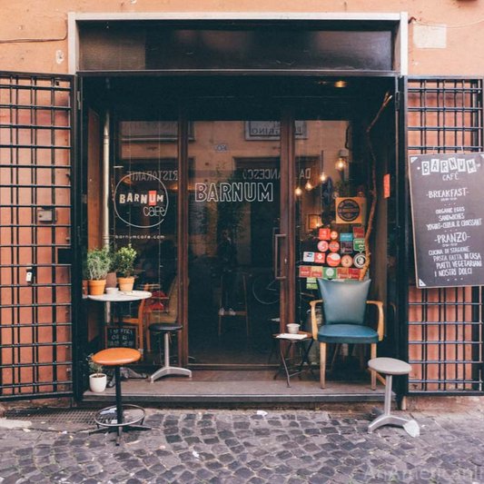 Front entrance of a cafe named 'Barnum Coffee' in Rome, Italy with outdoor seating area.