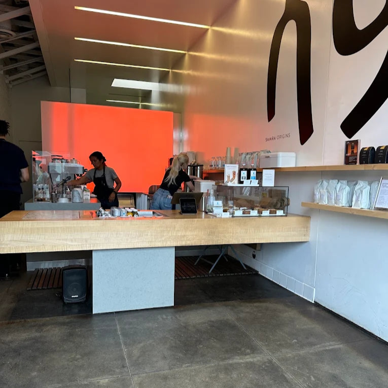 Modern interior of a specialty coffee shop with a counter and wall art.