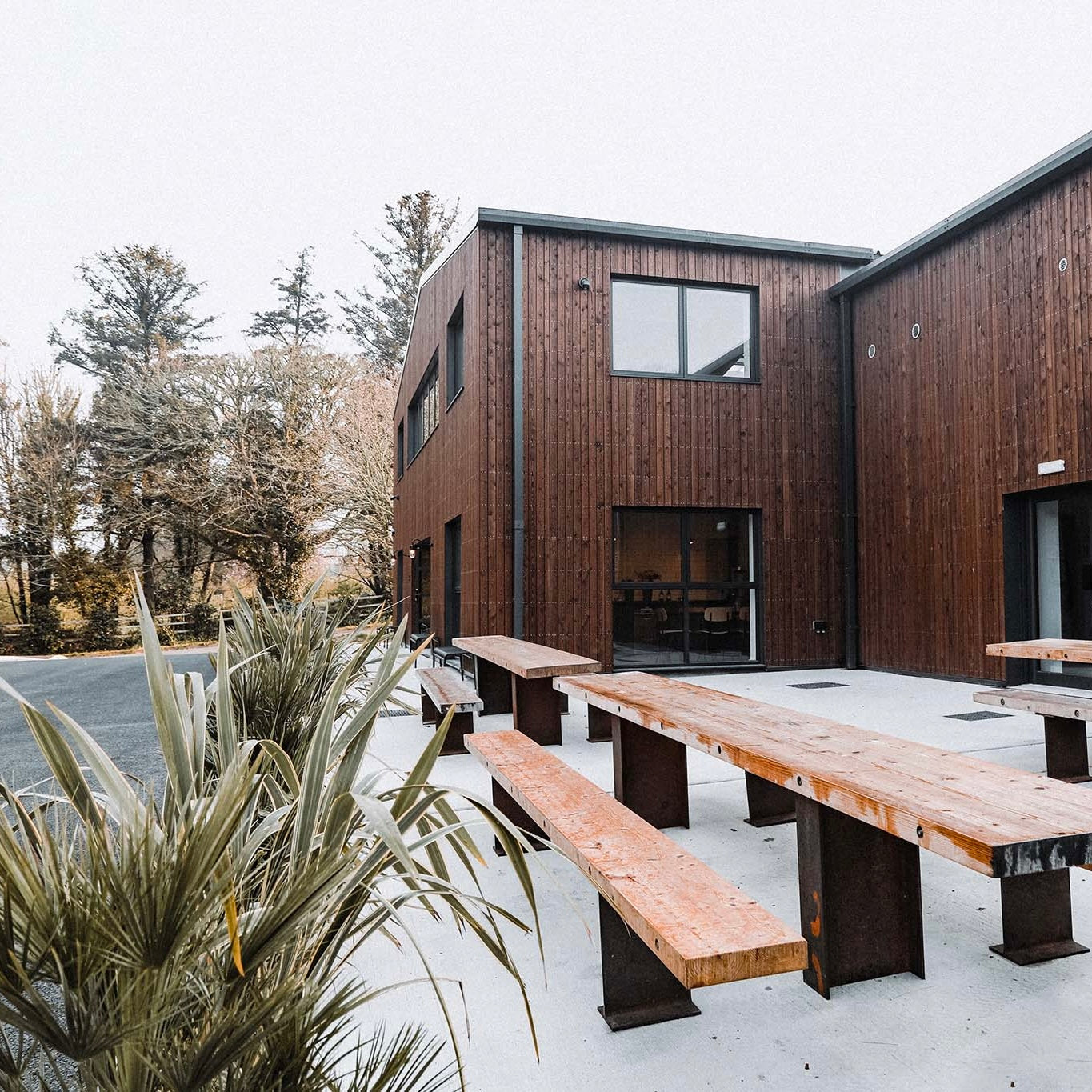 Modern wooden specialty coffee roaster with outdoor seating area