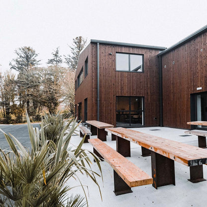 Modern wooden specialty coffee roaster with outdoor seating area