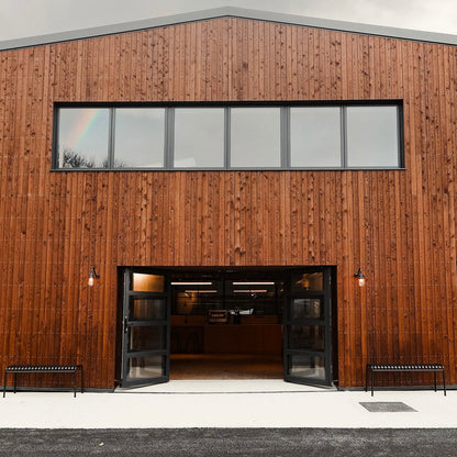 Modern third wave coffee roastery with wooden facade and glass doors